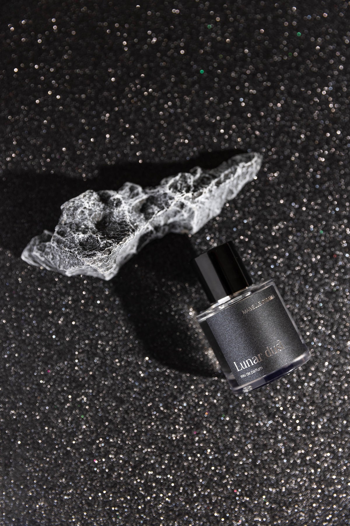 Lunar Dust bottle on black glitter