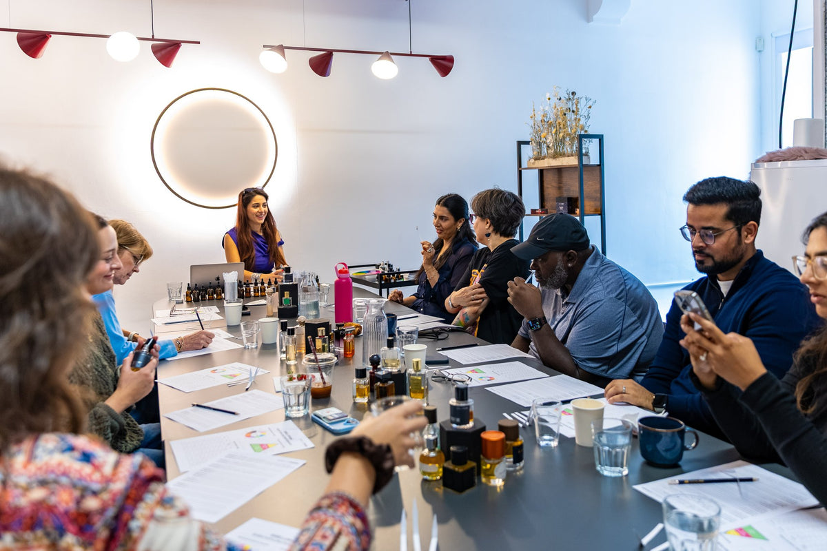 Guests smelling perfumes around the table at a Mabelle O'Rama workshop